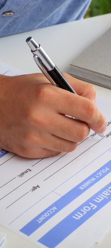 man-preparing-an-insurance-claim-form-PH7SDNH-1.jpg